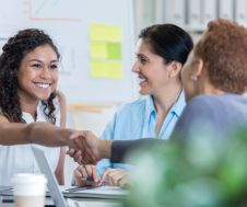 Happy employees shaking hands