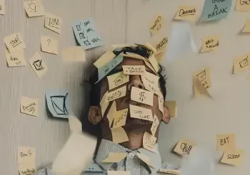 A stressed man with sticky notes all over his face, representing the burden of responsibilities.