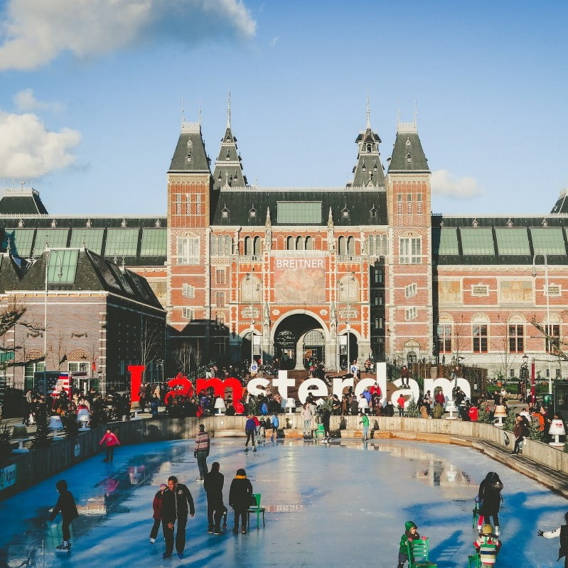 Amsterdam ice skating rink: People enjoying ice skating at an outdoor rink in Amsterdam.