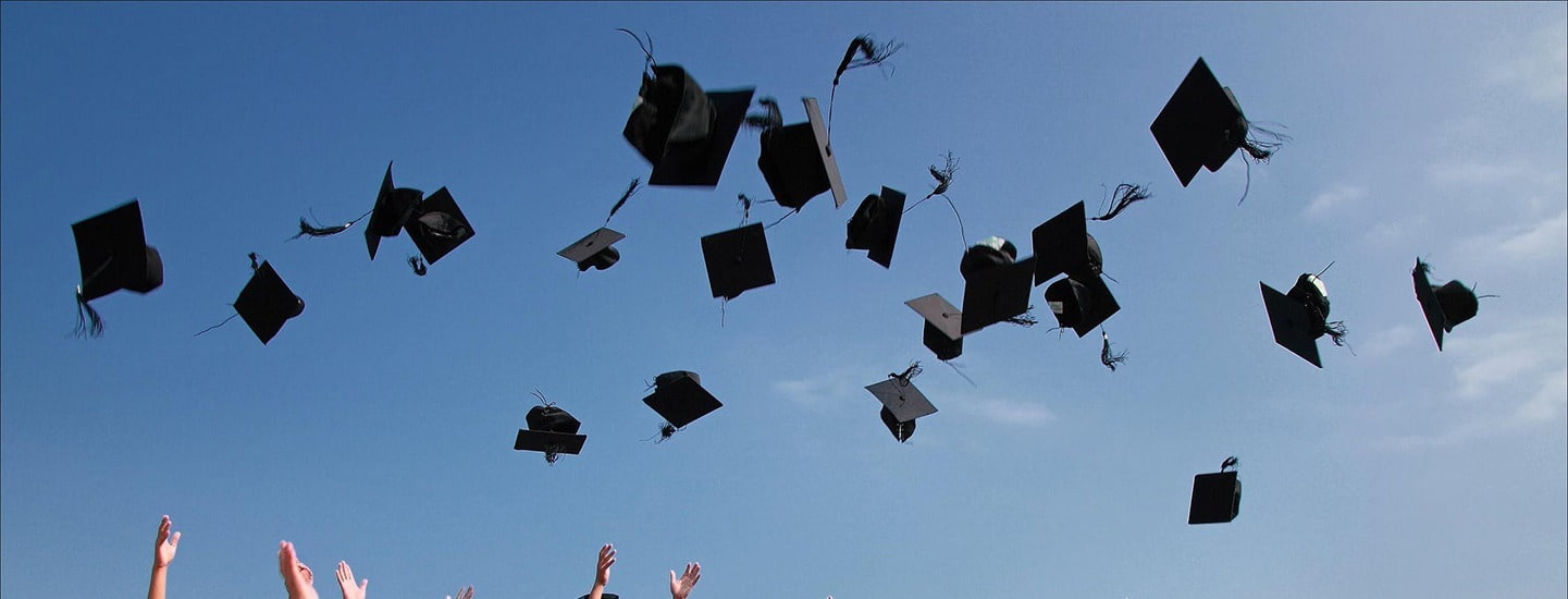 Graduates throwing their caps in the air, ready to kick-start their careers