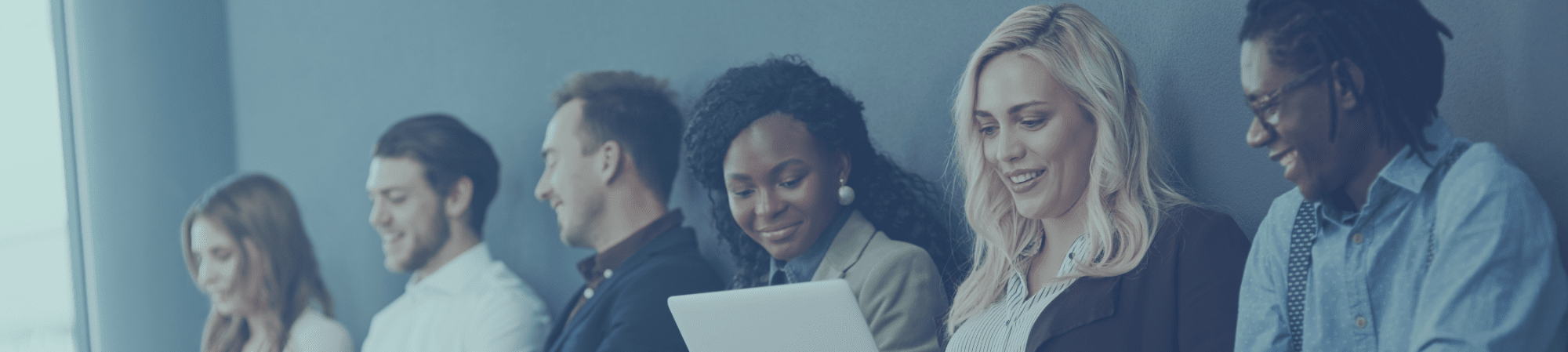 Candour Talent Recruitment Agency - Testimonials Page. Main Banner Photo of a group of candidates lined up, waiting to be interviewed, reflecting the recruitment process and showcasing the use of modern technology in candidate selection