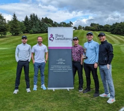 Aaron, Adam, Charlie and Jack standing next to our Sharp Consultancy branded banner at our annual golf event at Sickleholme Golf Club.