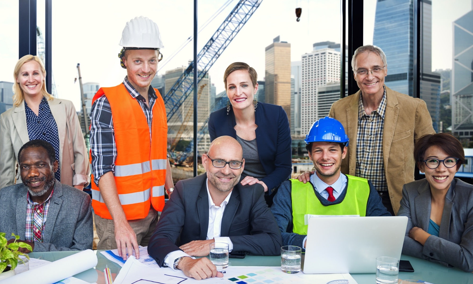 people from the hire industry standing hi vis jacket blue hat worker construction site