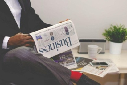 finance recruiter reading a business newspaper
