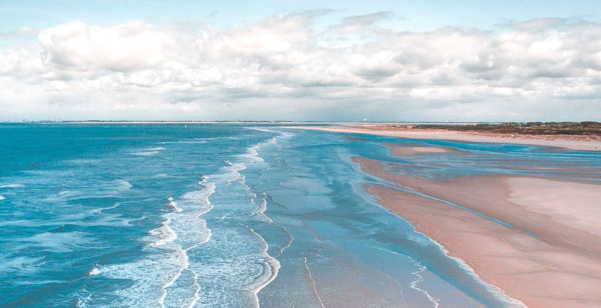 pastel ocean waves and pastel sand beach