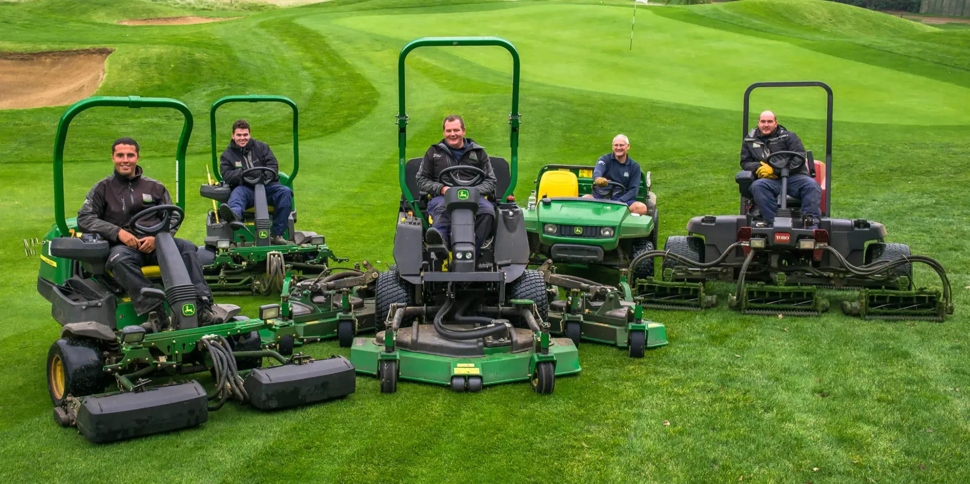 green keeping team at golf club smiling