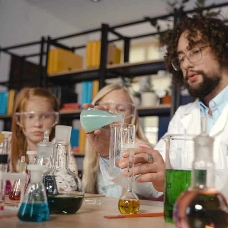 Science teacher doing experiment with students