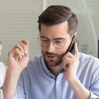 Sales Manager Consulting Client Talking On Phone In Office Picture Id1070271688 (1)