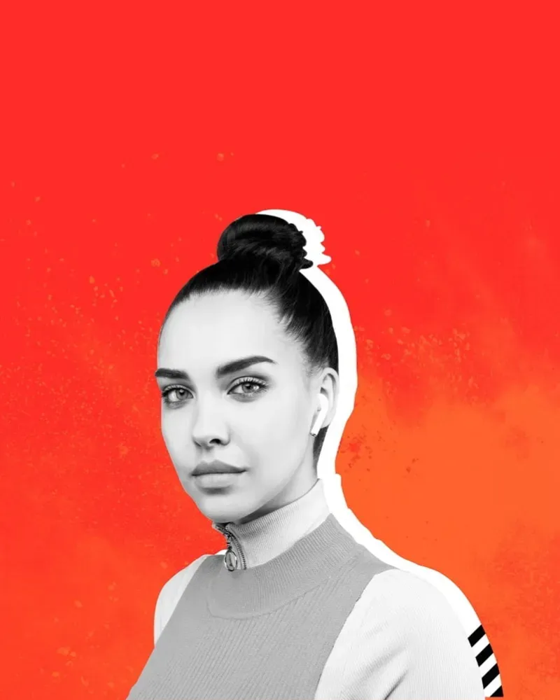 Woman standing against orange background