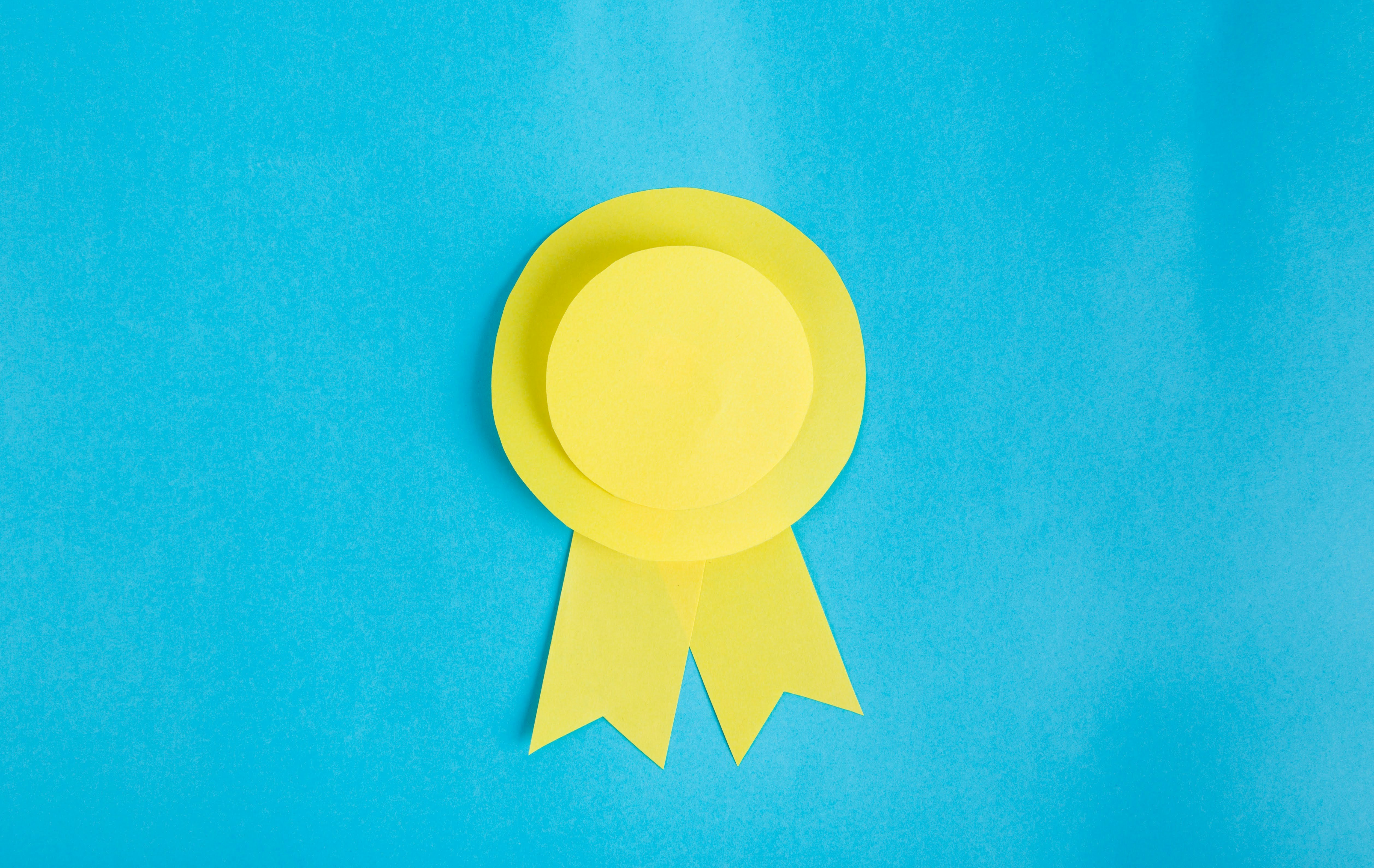 A yellow ribbon gracefully adorns a serene blue background, creating a harmonious contrast.