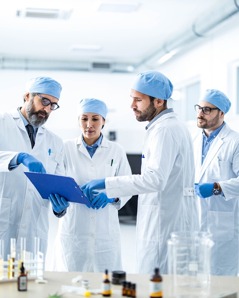 scientist in lab coats reading chart 