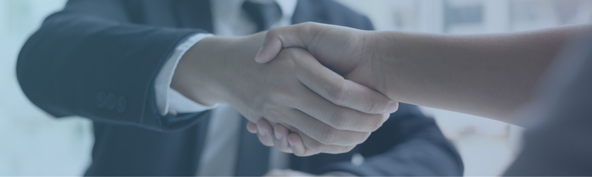Candour Talent Recruitment Agency - Partner with us Page. banner of a handshake in a professional working environment, symbolizing our commitment to forging strong partnerships and collaborations.