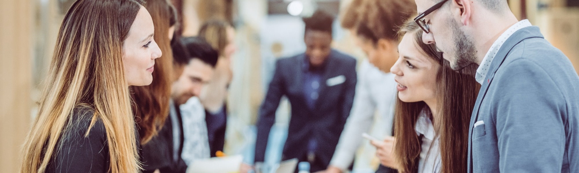 professionals speaking with business woman at career fair