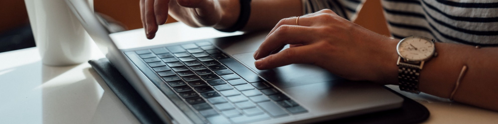 person typing on keyboard laptop prepping for interview