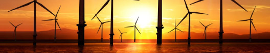 wind turbines in the sea with a sunset background