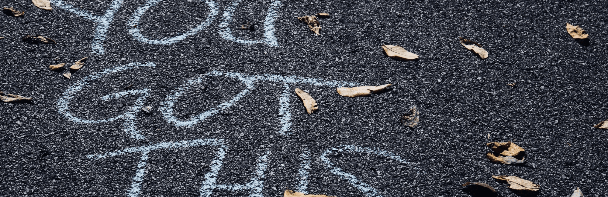 The phrase "you got this" is painted in bold letters on a gray asphalt surface.