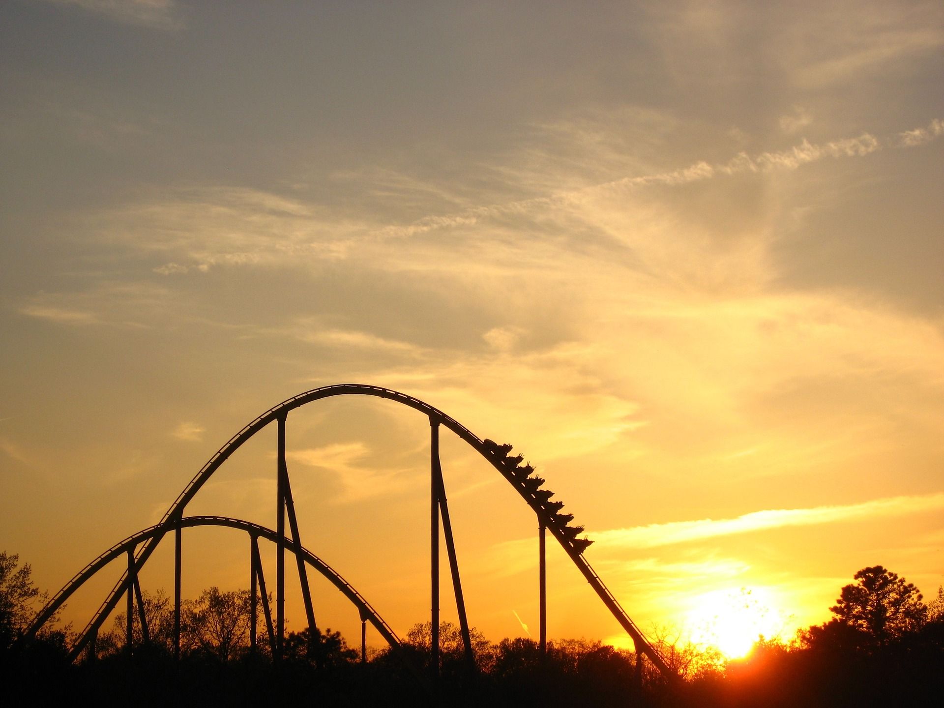 Sunset with a silhouette of a rollercoaster.