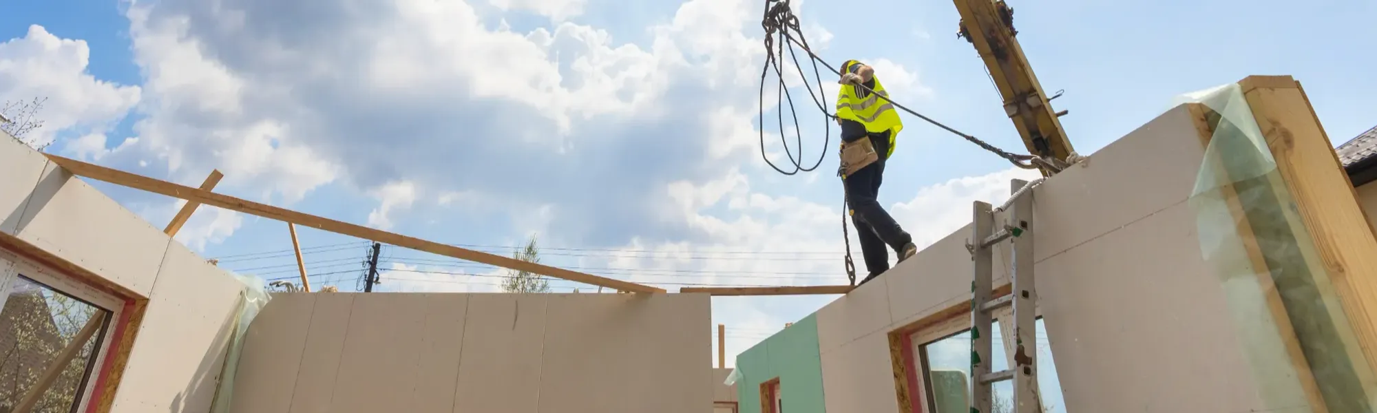 Construction worker overseeing a modular house build