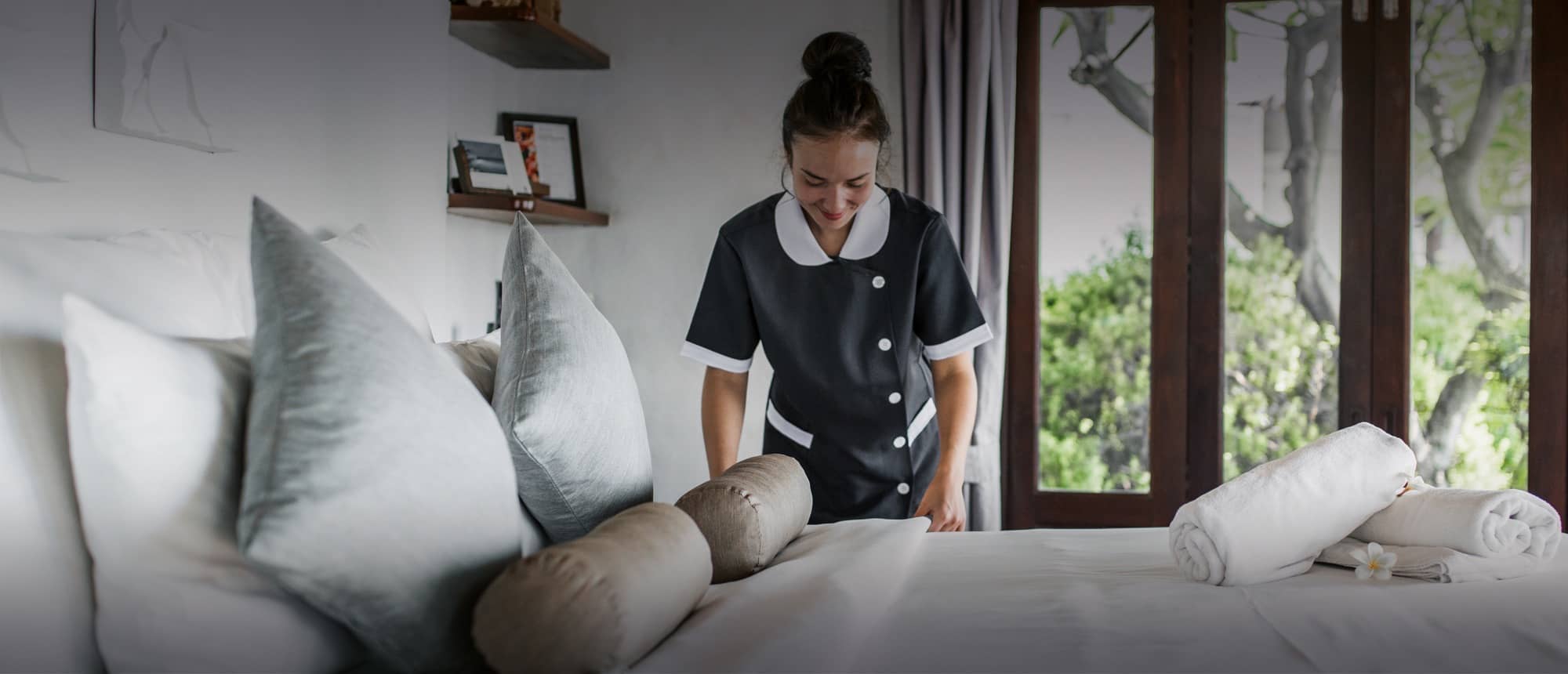 Housekeeper making bed