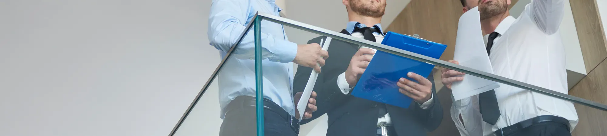 Generic image of three people studying printed documents