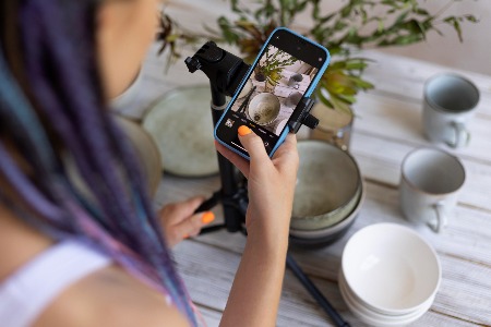 Woman taking content photos with phone