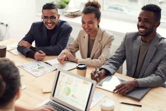 Young professionals sat around a desk