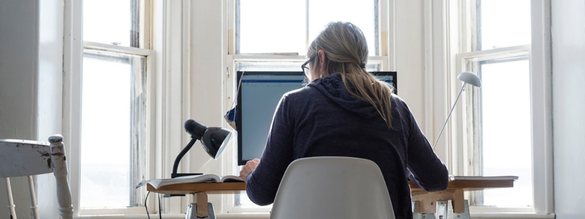 Working professional working remotely from home at desk