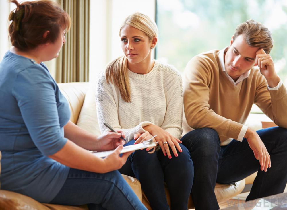 Woman And Man On Couch Near Therapist