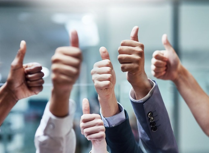 6 thumbs up in an office setting