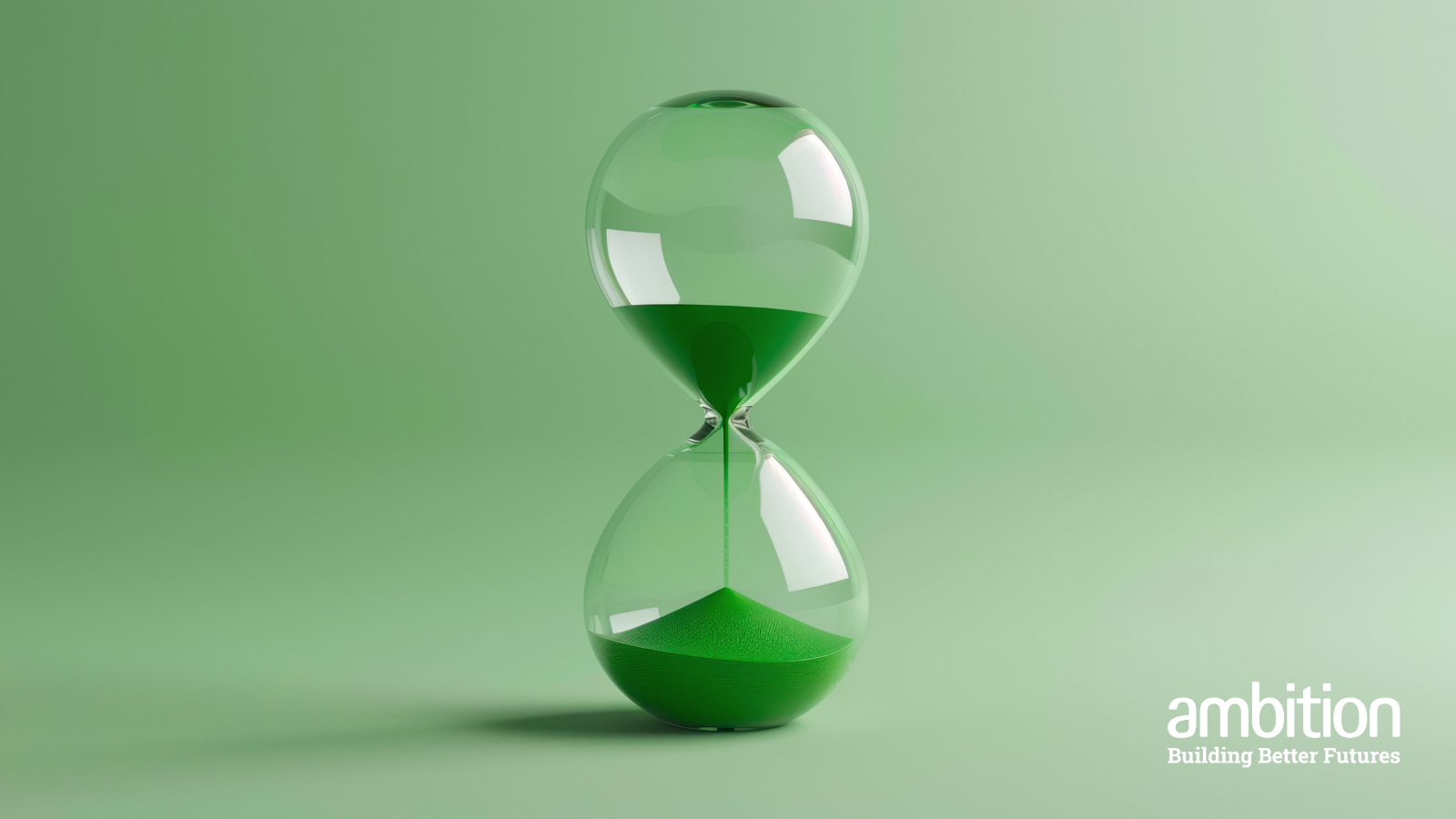 An hourglass with green sand, against a green backdrop. 