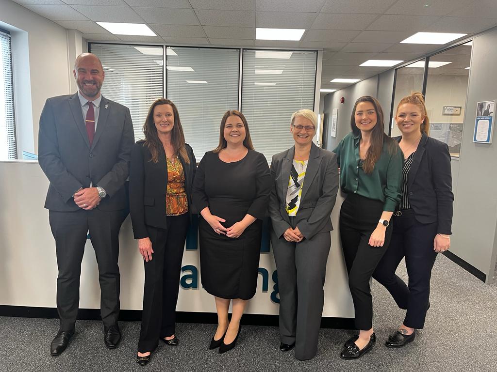 A woman holding a digital laser tape measure