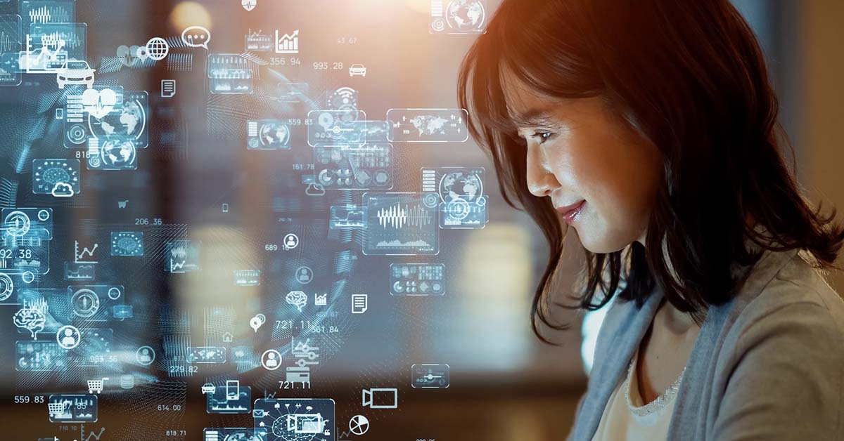 Japanese Woman Looking At A Holographic Screen Showing Business And Technology Concept