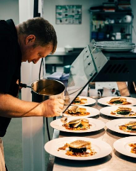 A person preparing food on plates  AI-generated content may be incorrect.