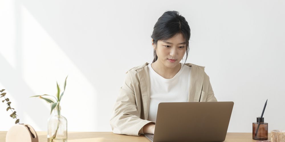Asian Woman Home Using Laptop Min