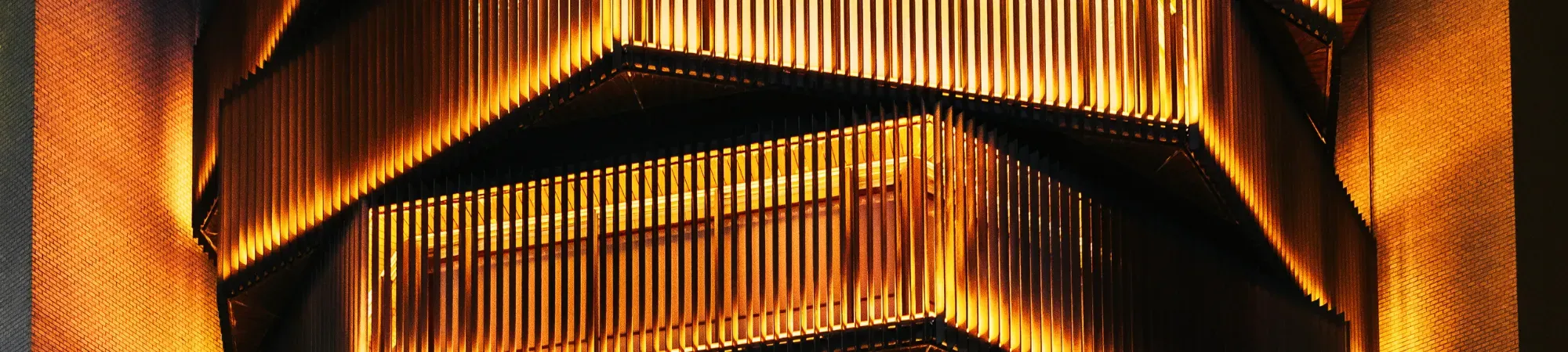 A bright orange building with vertical slats
