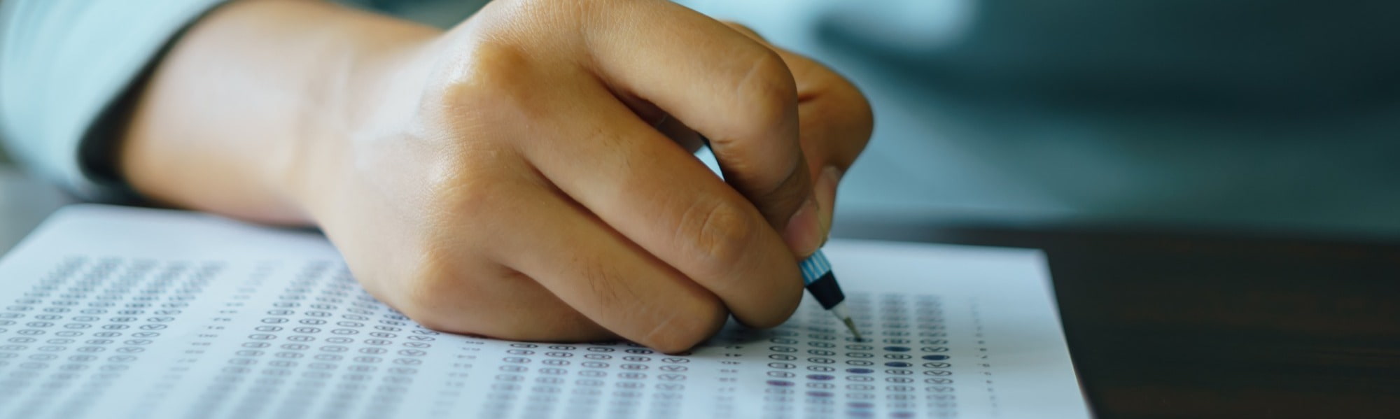 college student filling out mock assessment paper to prepare for career