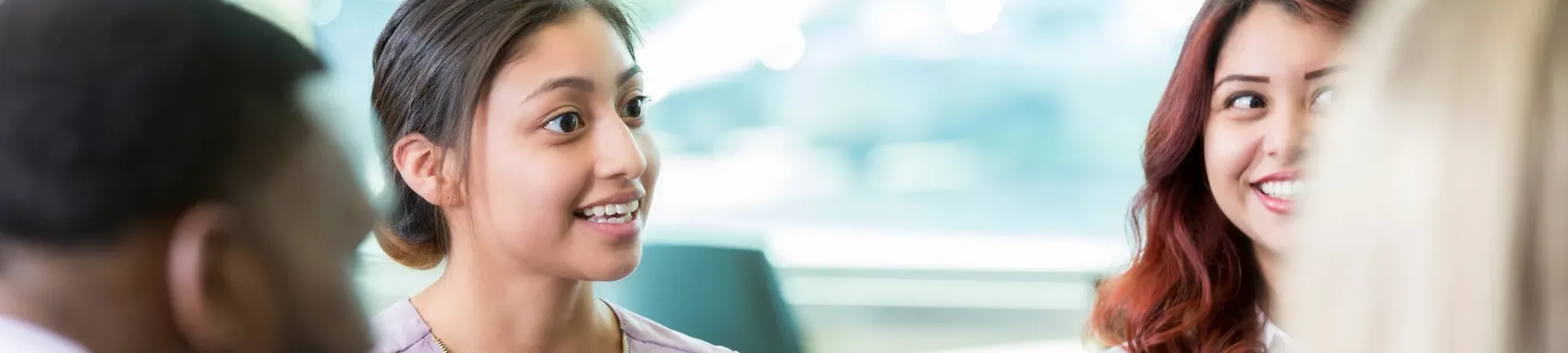 A woman smiling in a meeting