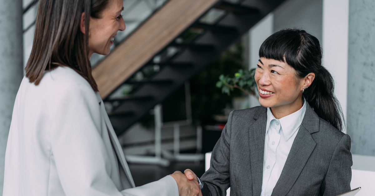 Japanese Business Woman Shaking Hands With Her Interviewer At Her Office Smiling