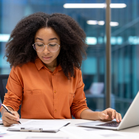 Lady in office looking at recruitment paperwork