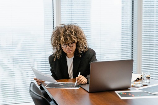 Woman working on desk with laptop