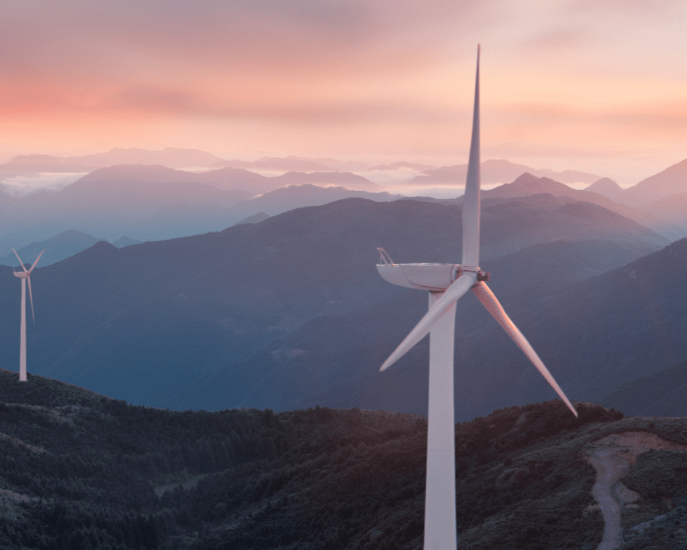 Wind turbines at sunset in the UK producing renewable generation power