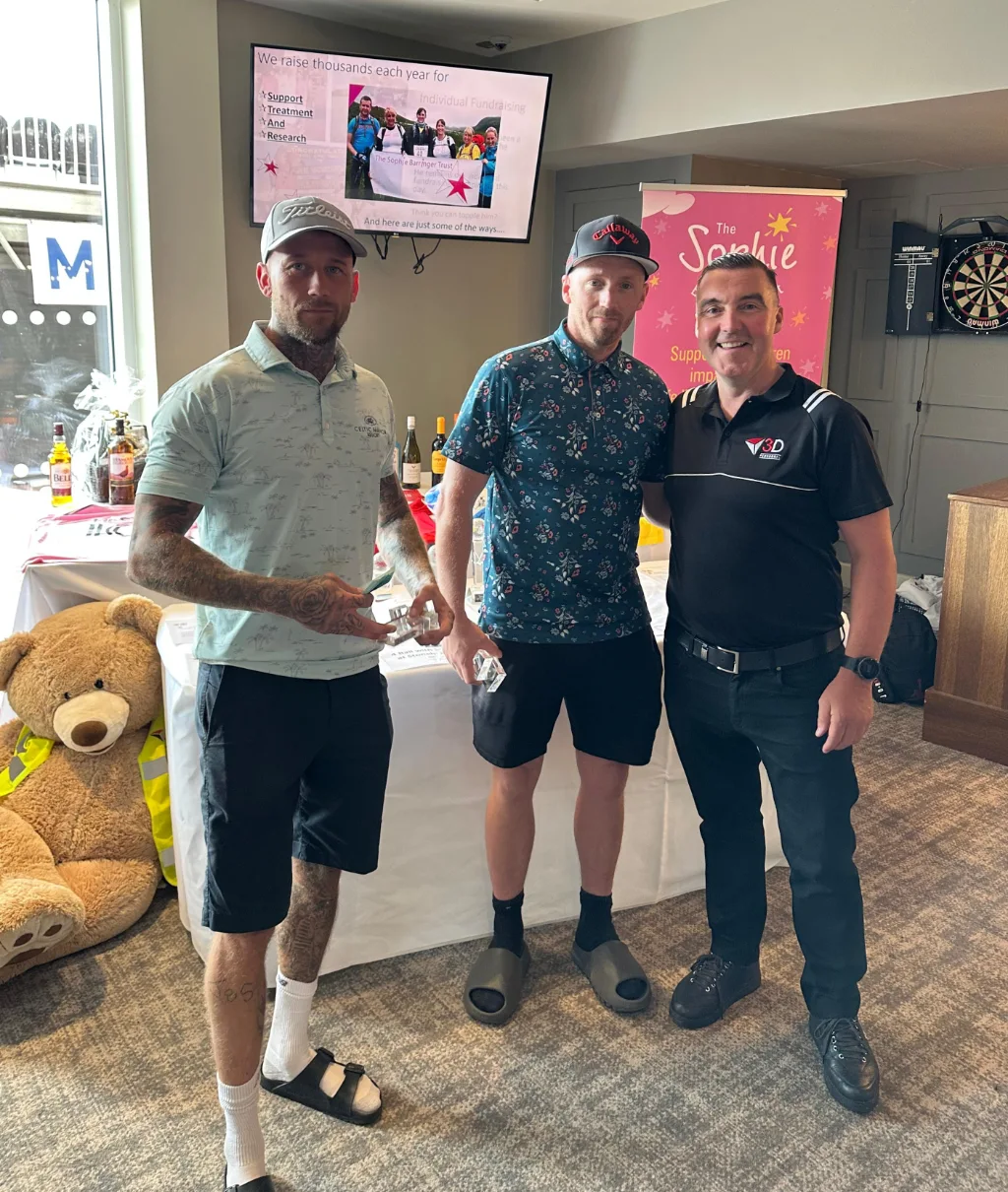 Members of the 2025 winning team from Harman Carpentry collect their trophies from Damian
