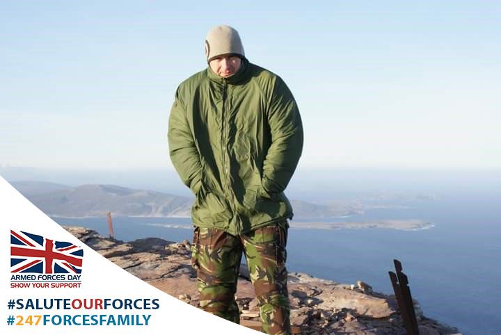 Dean stood on top of a mountain in Armed Forces uniform