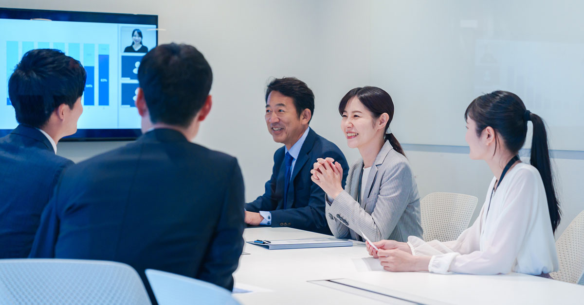 Japanese Person Who Is In Their 50s And Having A Meeting In The Meeting Room With Their Team