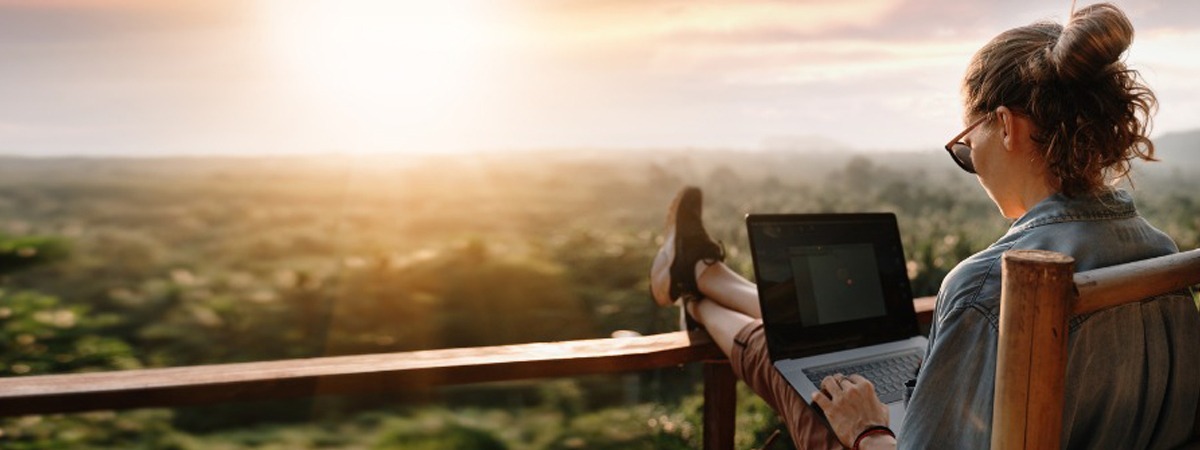 female working professional working remotely on laptop 