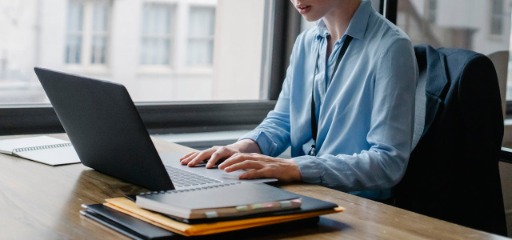 Woman sat at desk working on laptop