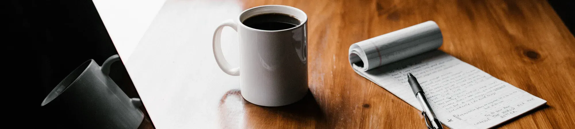 Generic image of a cup of coffee and a notepad