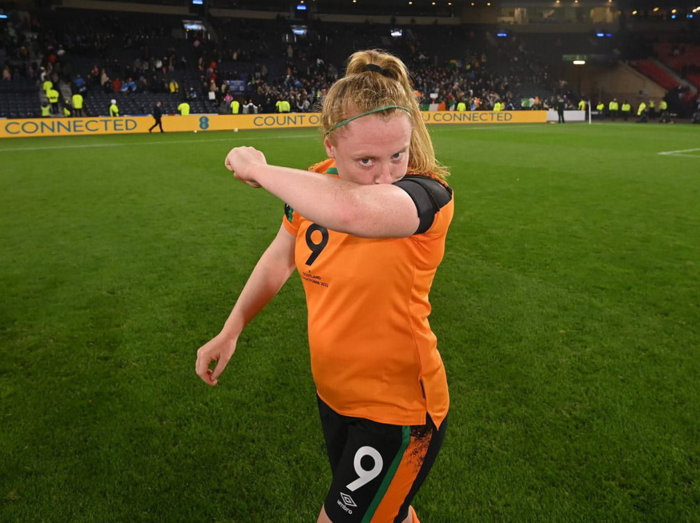 Amber Barrett kisses her black armband after scoring her winning goal against Scotland