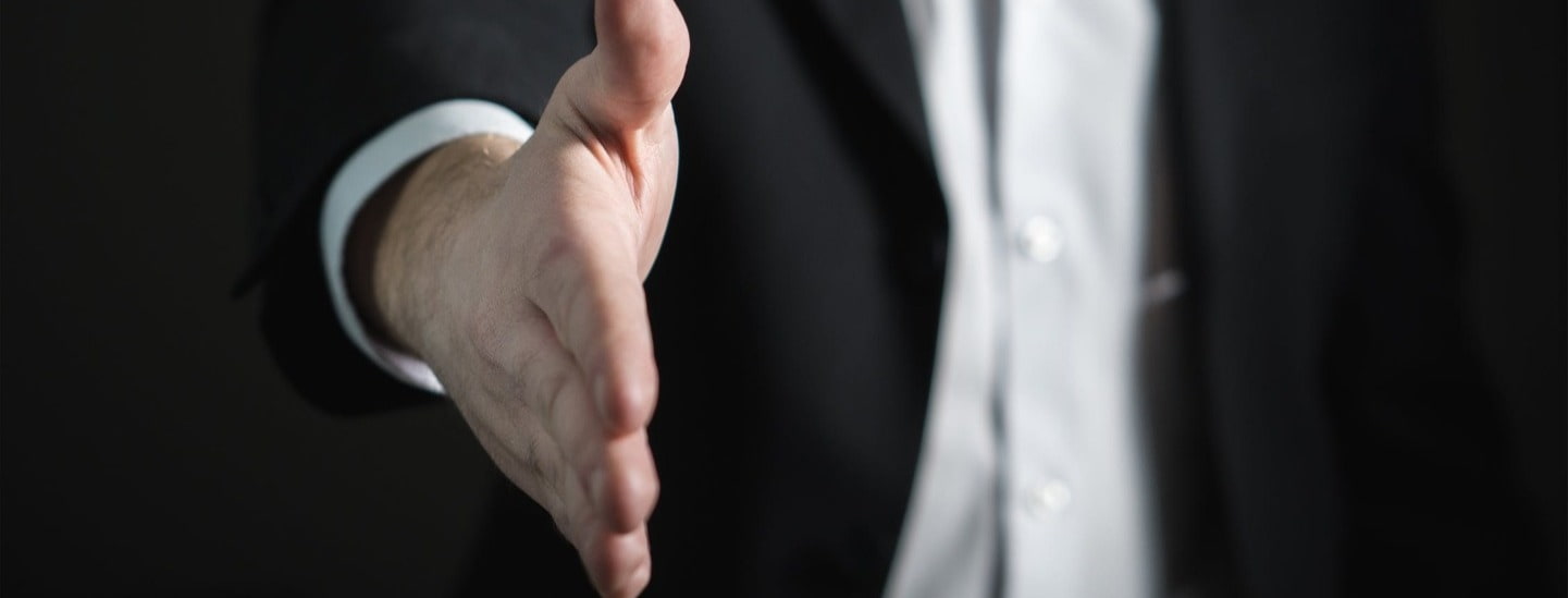 Business person offering handshake to make a good first impression in an interview