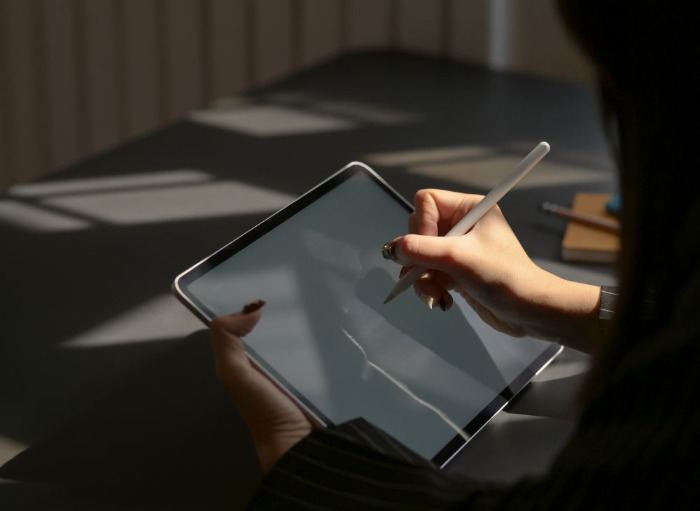 employee completing a survey on a tablet